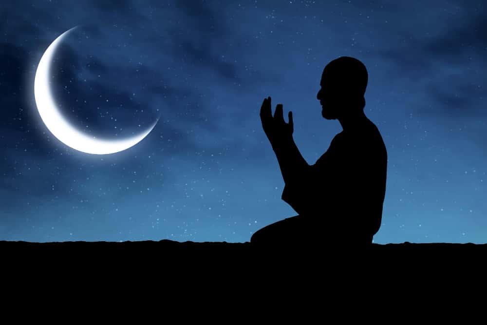 A crescent moon shining against a dark night sky, observed for the start of the Islamic month